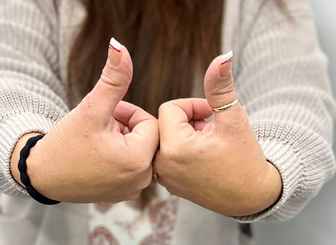 Read Our Reviews - Closeup View of Covenant Insurance Family Team Member Holly Giving Thumbs Up